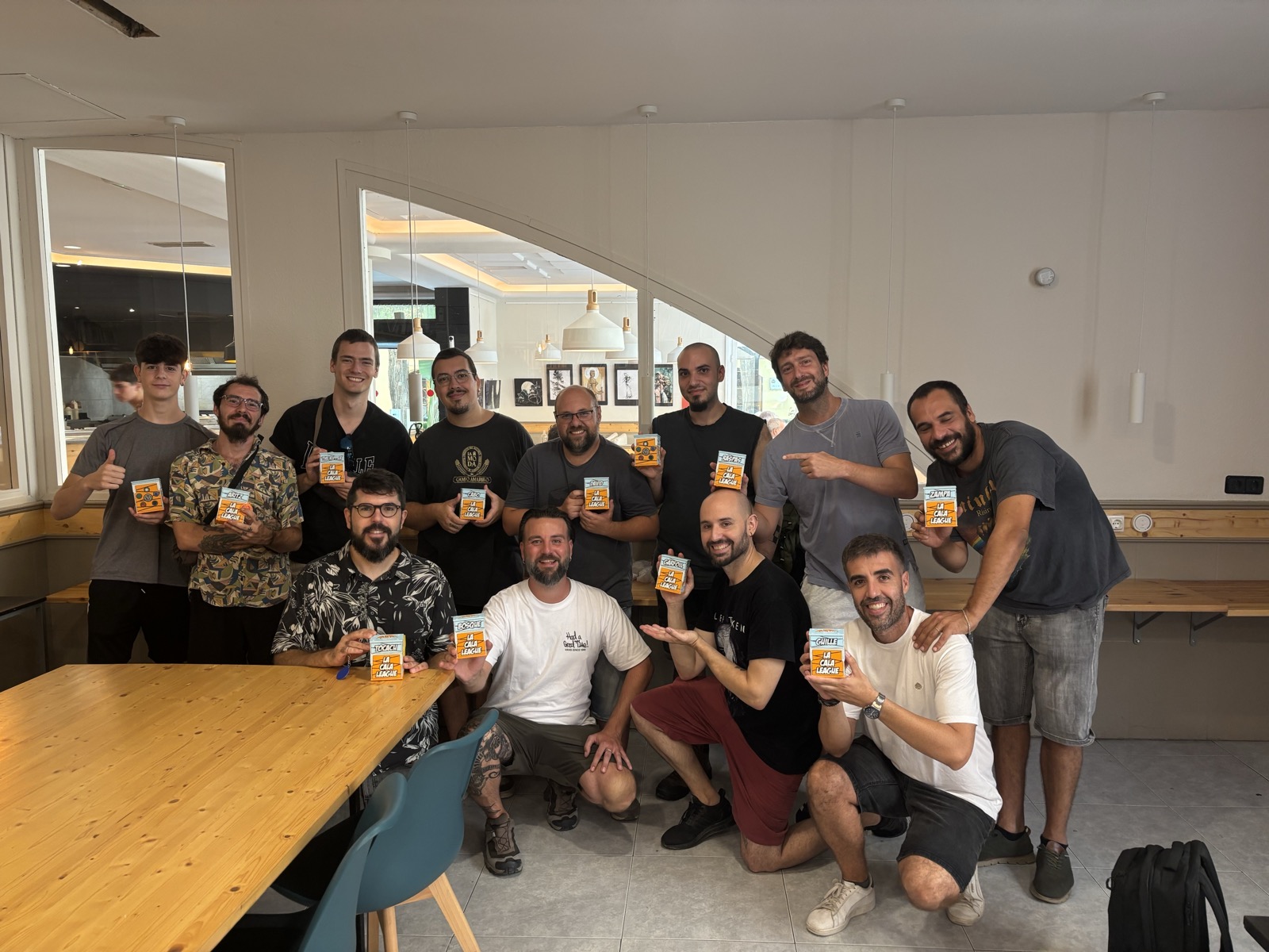 La Cala League members holding their personalized league boxes after The Hobbit draft tournament